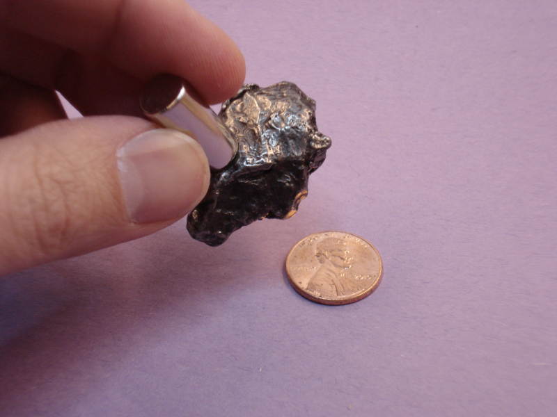 Using a neodymium cylinder magnet to identify a rock as a meteorite from outer space