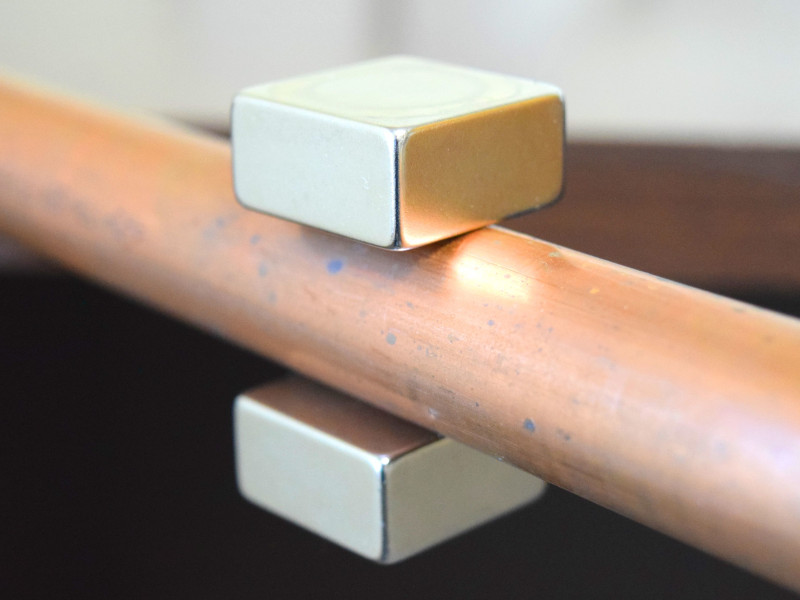 Magnetic water treatment magnets on a copper pipe conditioning water