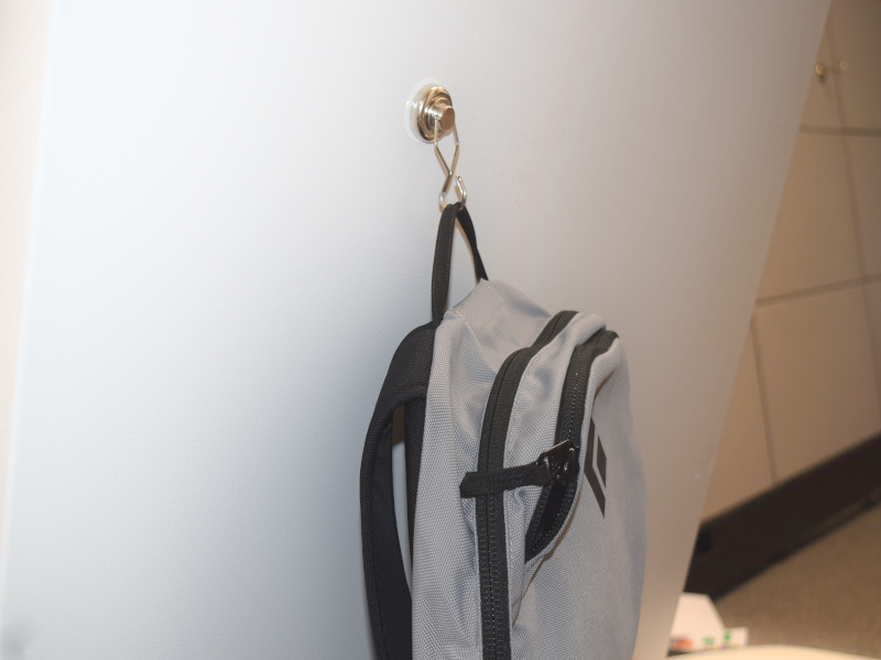 Spinning hook hanging bag on angled wall