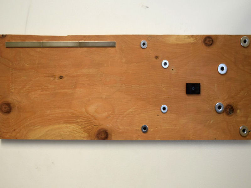 Board hanging on metal door with magnets attached for holding tools