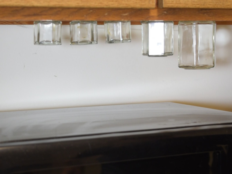 Magnetic jars hanging from under cabinets