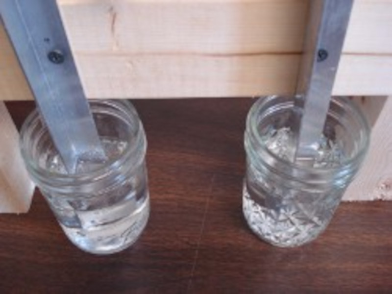 Metal bars in heated water to test scale buildup after magnetic water softening