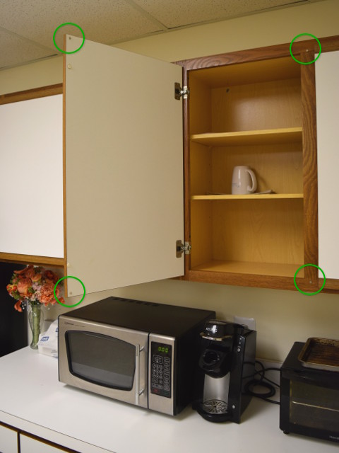 Open cabinet door with magnets on backside