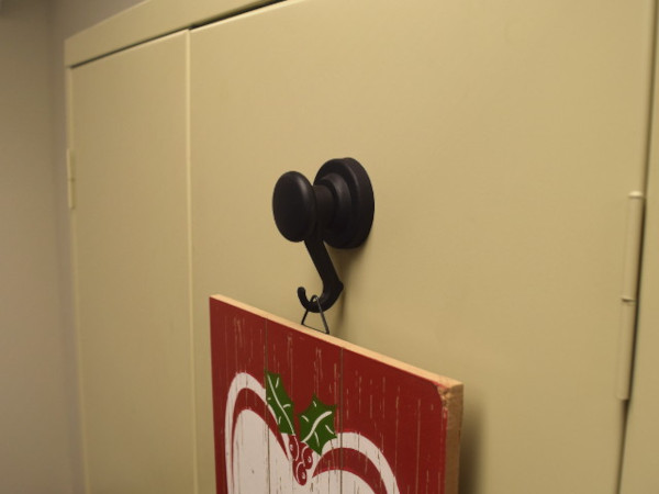 Magnetic hooks being used to hang things on metal surfaces and
                    more.