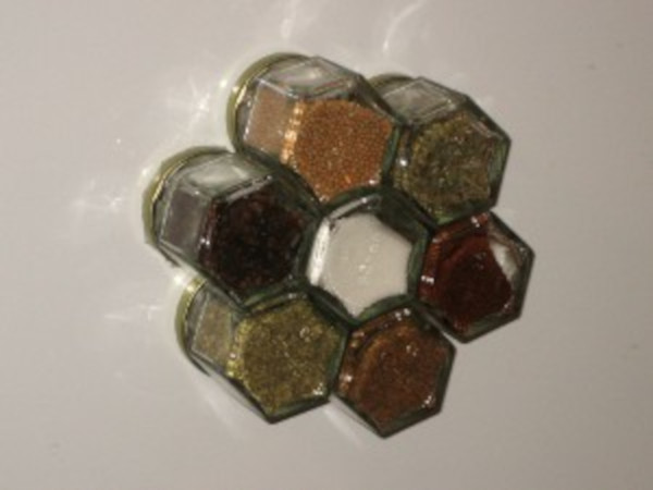 Magnetic spice jars conveniently hanging seasonings on the fridge to save space