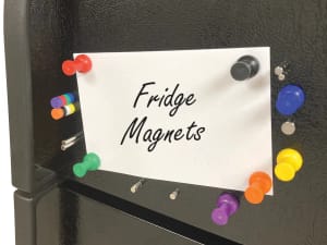 Colorful strong neodymium magnets holding picture on fridge